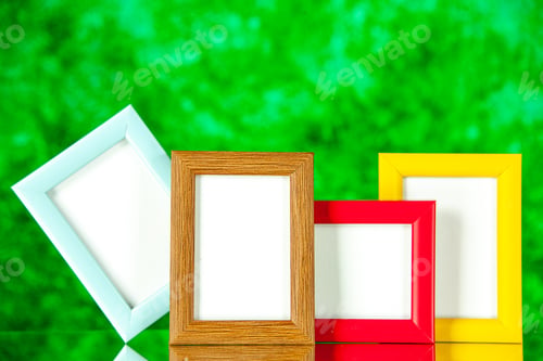 Preview: front view different picture frames with colored corners on a green background present picture