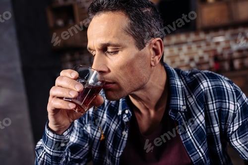Preview: portrait of man with glass of alcohol at home