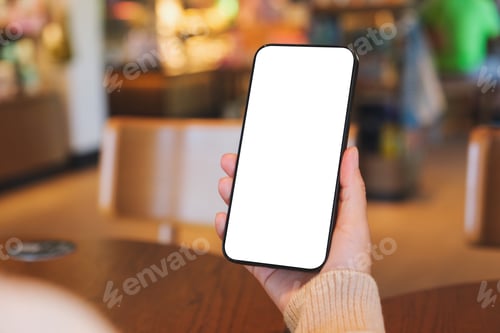 Preview: Mockup image of a woman holding and using mobile phone with blank desktop screen in cafe
