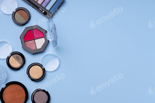 Preview: Set of eyeshadows on blue background close up