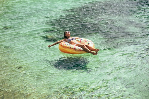 Preview: Woman Floating on Inner Tube in Water