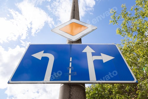 Preview: Bottom view of roadsign main road with tablet with direction allowed on crossroads against sky
