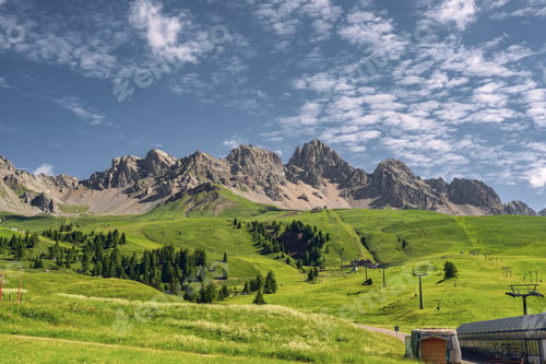 Preview: Idyllic landscape with mountain and green grass on field