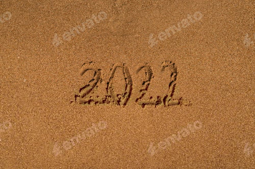 Preview: 2022 is drawing on sand on a beach with a wave by the sea. Vacation on the sea. New Year concept