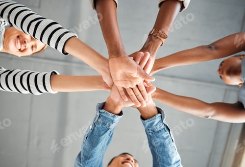 Preview: Group of businesspeople piling their hands together in an office at work. Business professionals ha