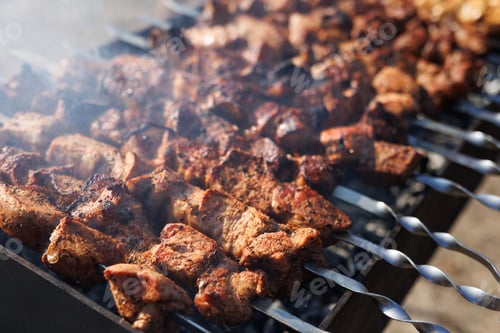 Preview: Marinated shish kebab, shashlik is cooked on a barbecue grill on coals.
