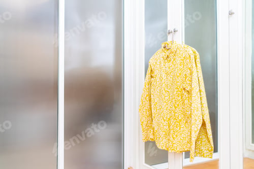 Preview: Long-sleeved shirt hanging in front of the wardrobe