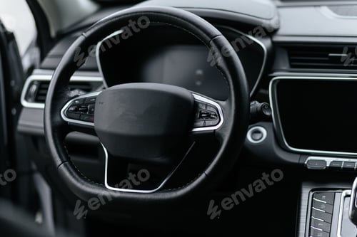 Preview: Close-Up Of Black Leather Steering Wheel In Modern Car Interior