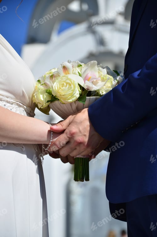 Preview: The newlywed couple is holding a beautiful wedding bouquet