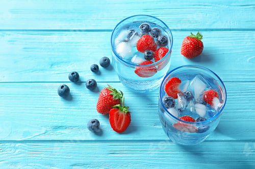 Preview: Natural lemonade with berries in glasses on wooden table