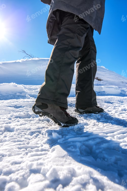 Preview: Winter snow hiking, woman walking on snowy path