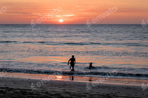 Preview: Man and dog silhouette at Beautiful sunset in Mancora Beach - Mancora, Peru