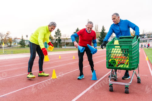 Preview: Senior Runners Engaged in Track Setup with Cones