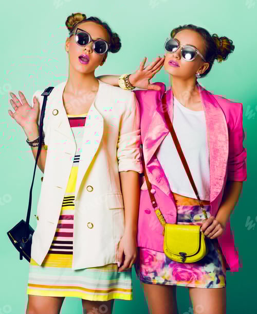 Preview: Fashion studio image of two young women in stylish casual spring outfit having fun,
