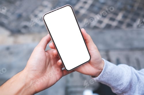 Preview: A couple people holding and looking at the same mobile phone with blank desktop screen