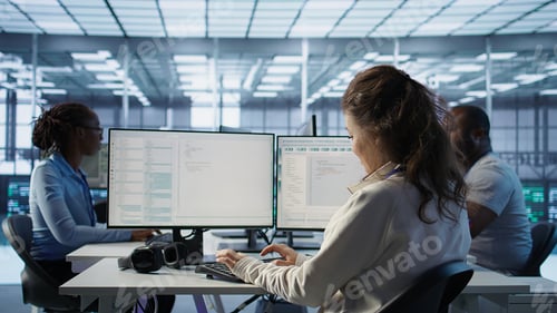 Preview: Smiling manager in server hub using computer to find firewall misconfigurations