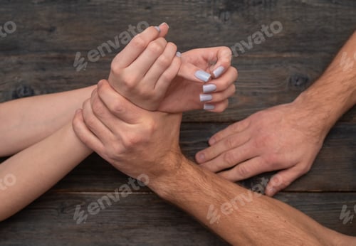 Preview: Female wrist held by strong male hand, symbolizing fragility, power imbalance