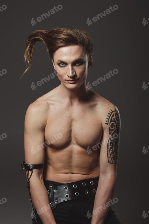 Preview: shirtless tattooed man with strange hairstyle, isolated on grey