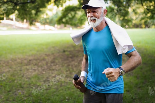Preview: Portrait of athletic mature man after run. Handsome senior man resting after jog at the park