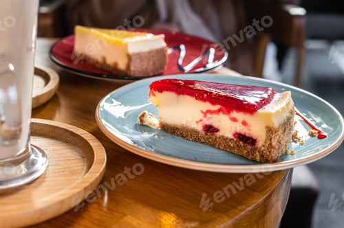Preview: Classic New York strawberries and lemon Cheesecake on a wooden table in cafe. Top view