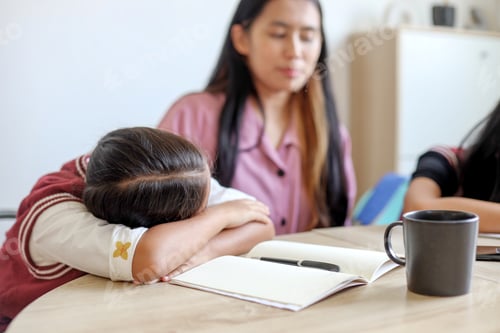 Preview: Lazy Little Girl Doing Homework With Writing On Book And Lying On Table