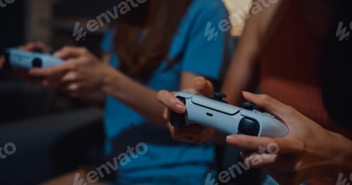 Preview: Asia ladies hand enjoy happy moment use controller gamepad playing video game in home at dark night.