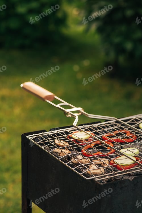 Preview: preparing of delicious mushrooms and bell pepper at picnic