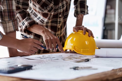 Preview: Architect and Engineer working with blueprints for architectural plan, engineer sketching a