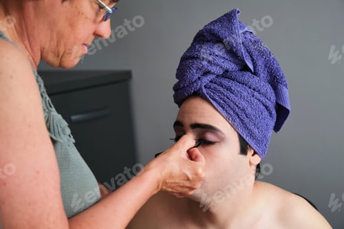 Preview: Mother sticking false eyelashes to her young transgender son.