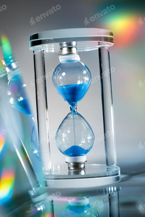 Preview: Blue hourglass on gray background close up