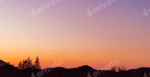 Preview: Sunset sunrise yellow orange purple golden sky with mountain.