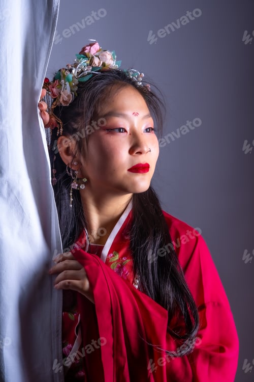 Preview: She has red lipstick and is wearing earrings
