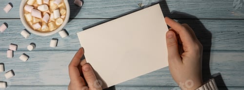 Preview: Banner Female hands holding empty greeting or invitation card mock up with white cup of coffee and