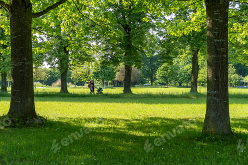 Preview: Peaceful park scene with a family walking under lush green trees on a sunny day