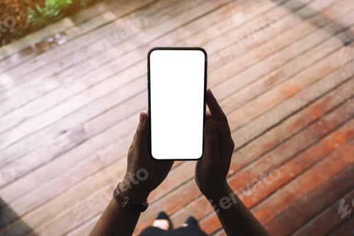 Preview: Top view mockup image of a woman holding black mobile phone with blank desktop screen