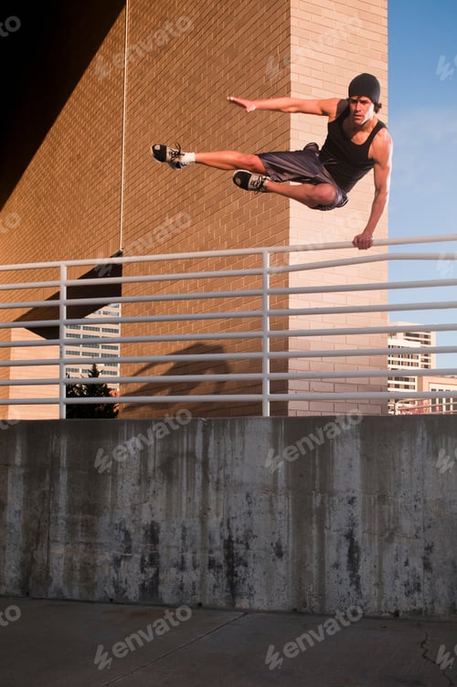 Preview: Athlete jumping over urban wall