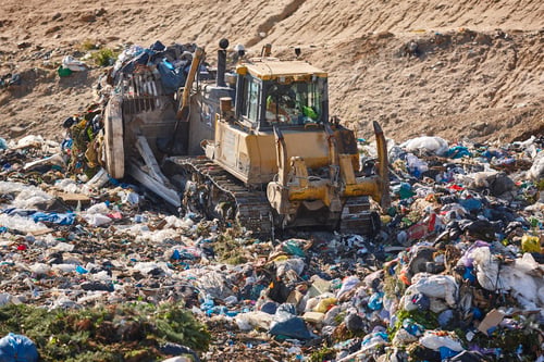 Preview: Heavy machinery shredding garbage in an open air landfill. Pollution