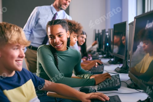 Preview: Multi-Cultural Group Of Secondary Or High School Students At Computers In IT Class With Male Teacher