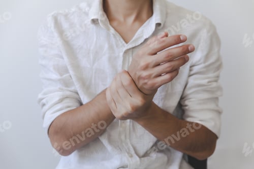 Preview: Selective focus shot of a male holding his painful wrist