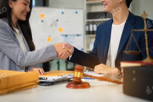 Preview: Business people and lawyers discussing contract papers sitting in the table at office