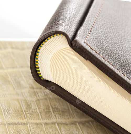Preview: Elegant leather photo album showing its spread pages on textured surface