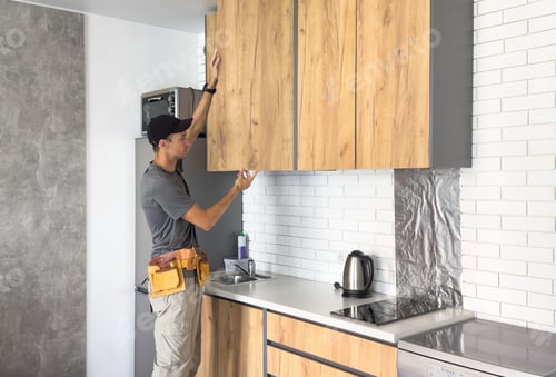 Preview: The carpenter finalizing the assembly of the kitchen shelf on the wall.