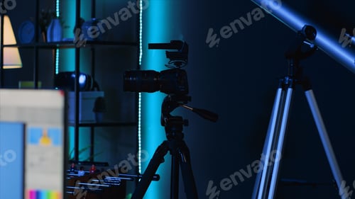 Preview: Professional camera equipment in empty blue neon lit creative photography studio