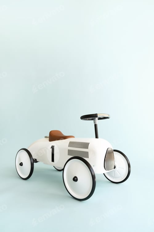 Preview: Retro style beige toy car on blue background. Stylish toy for toddler boy.