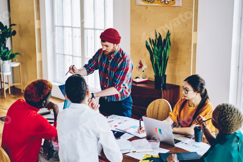 Preview: Diverse people discussing creative ideas for project teamworking at meeting table