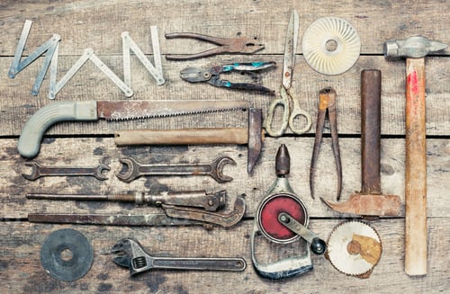 Preview: Collection of various hand tools arranged neatly on a rustic wooden surface for DIY enthusiasts and