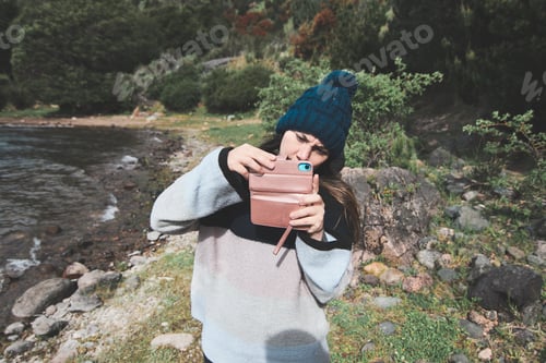 Preview: Young woman taking pictures with her mobile phone