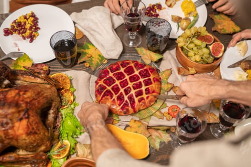 Preview: Hands of mature man with sharp knife cutting tasty homemade pie with jam