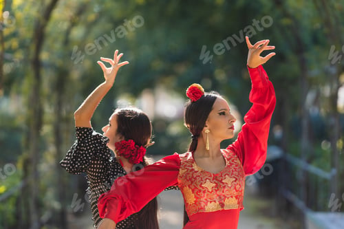 Preview: Two women in flamenco traditional costume dancing back to back outdoors