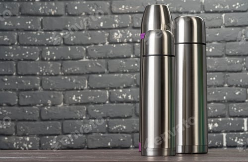 Preview: Aluminum metal thermos container bottle close up on table